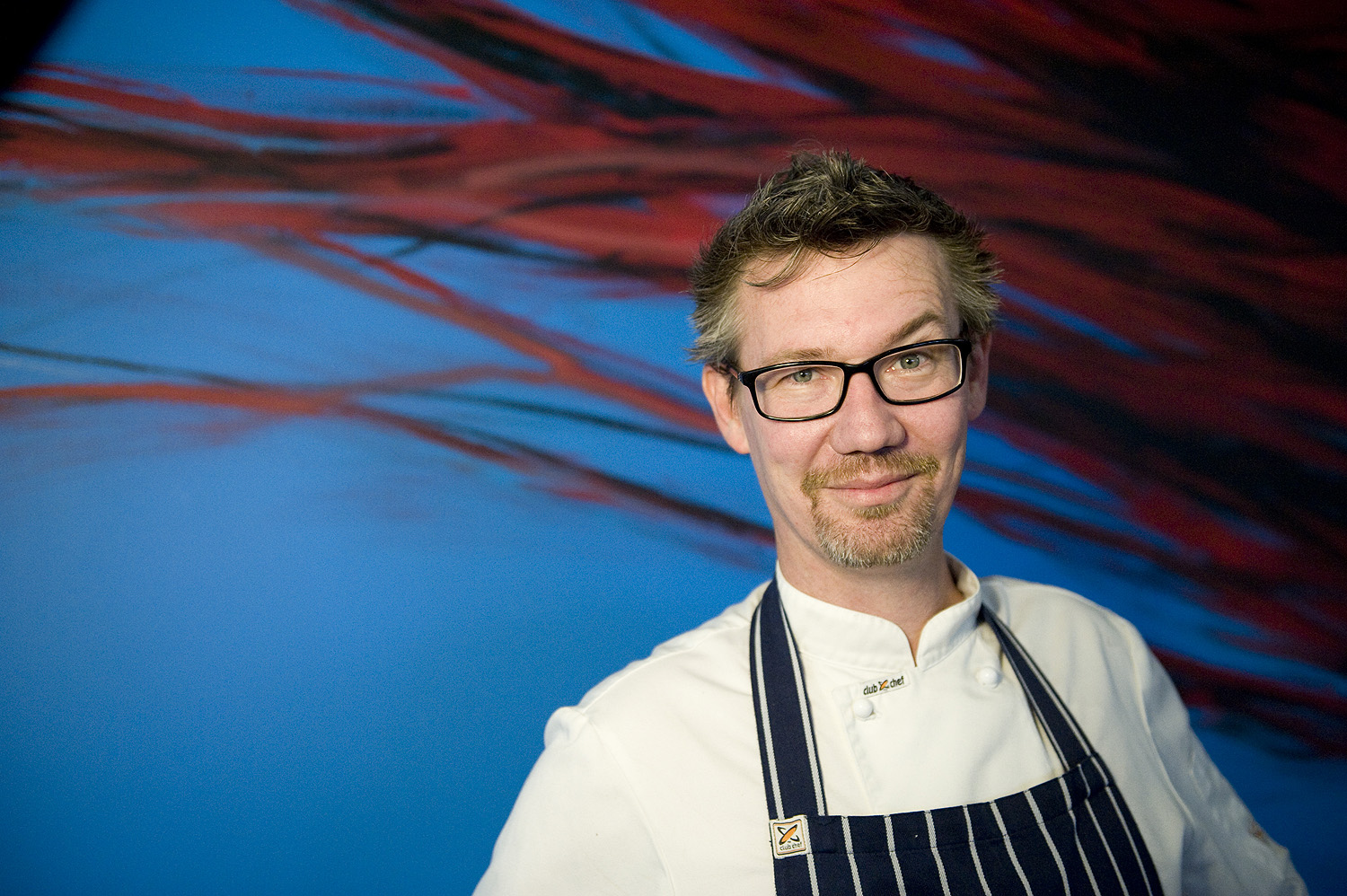 Chef sunny gilbert in front of mt erica mural