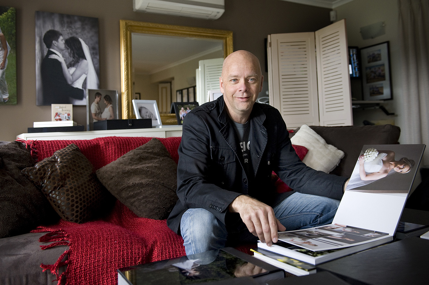 Wedding Photographer Andrew Harrison in his home studio viewing room