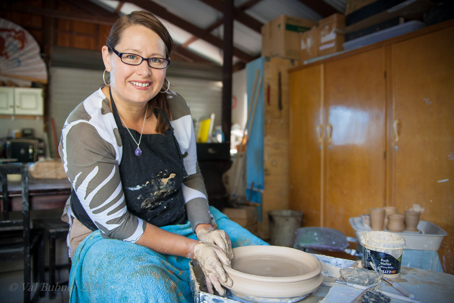 Tania Kunze a ceramic artist from Adelaide working on piece on the pottery wheel