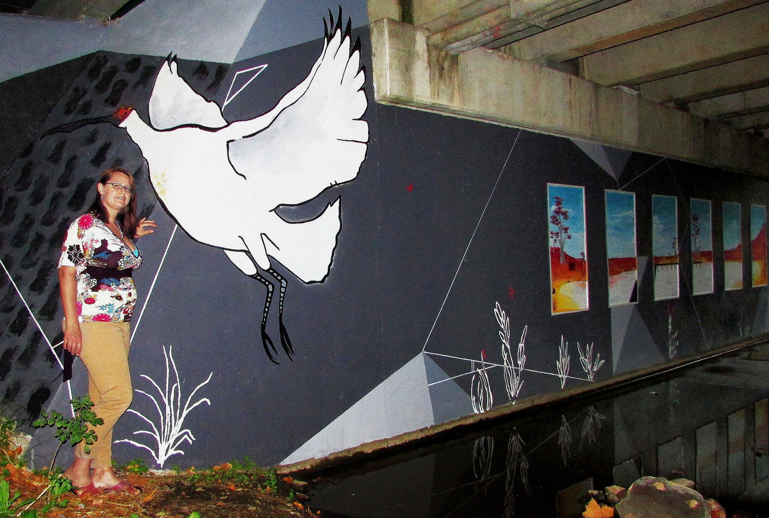 Tania Kunze an Adelaide artist in front of the mural she helped create