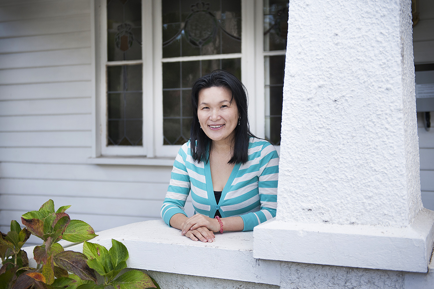 Property Investor tina koh on the porch of her bayside home